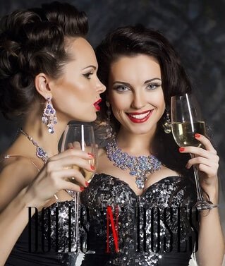 Christmas. Banquet. Two festive young fashion women with wine glasses of champagne