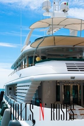 Luxury yacht with Italian flag docked in marina on a bright day